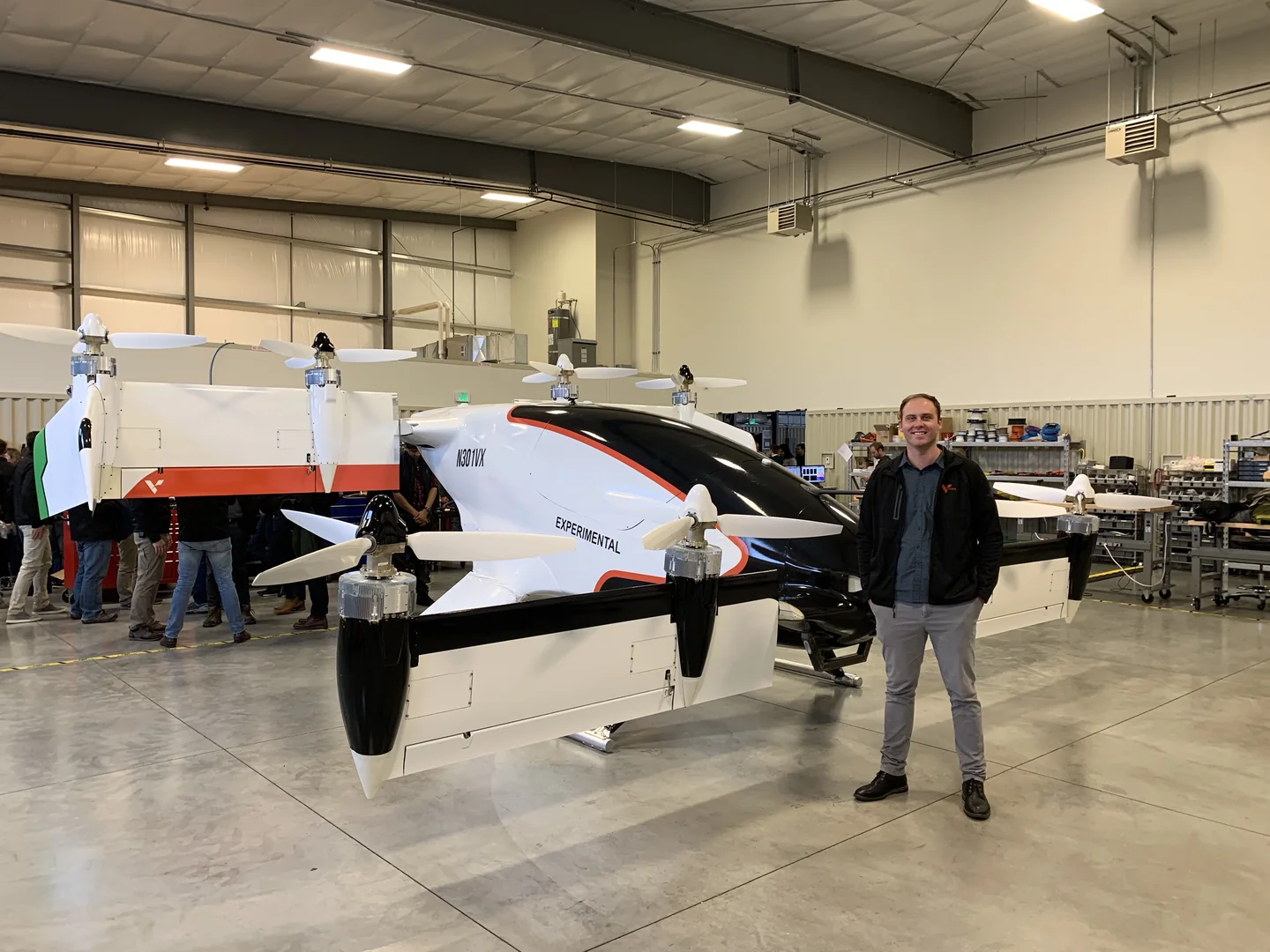 Maxwell Duke beside the Vahana aircraft in a hangar